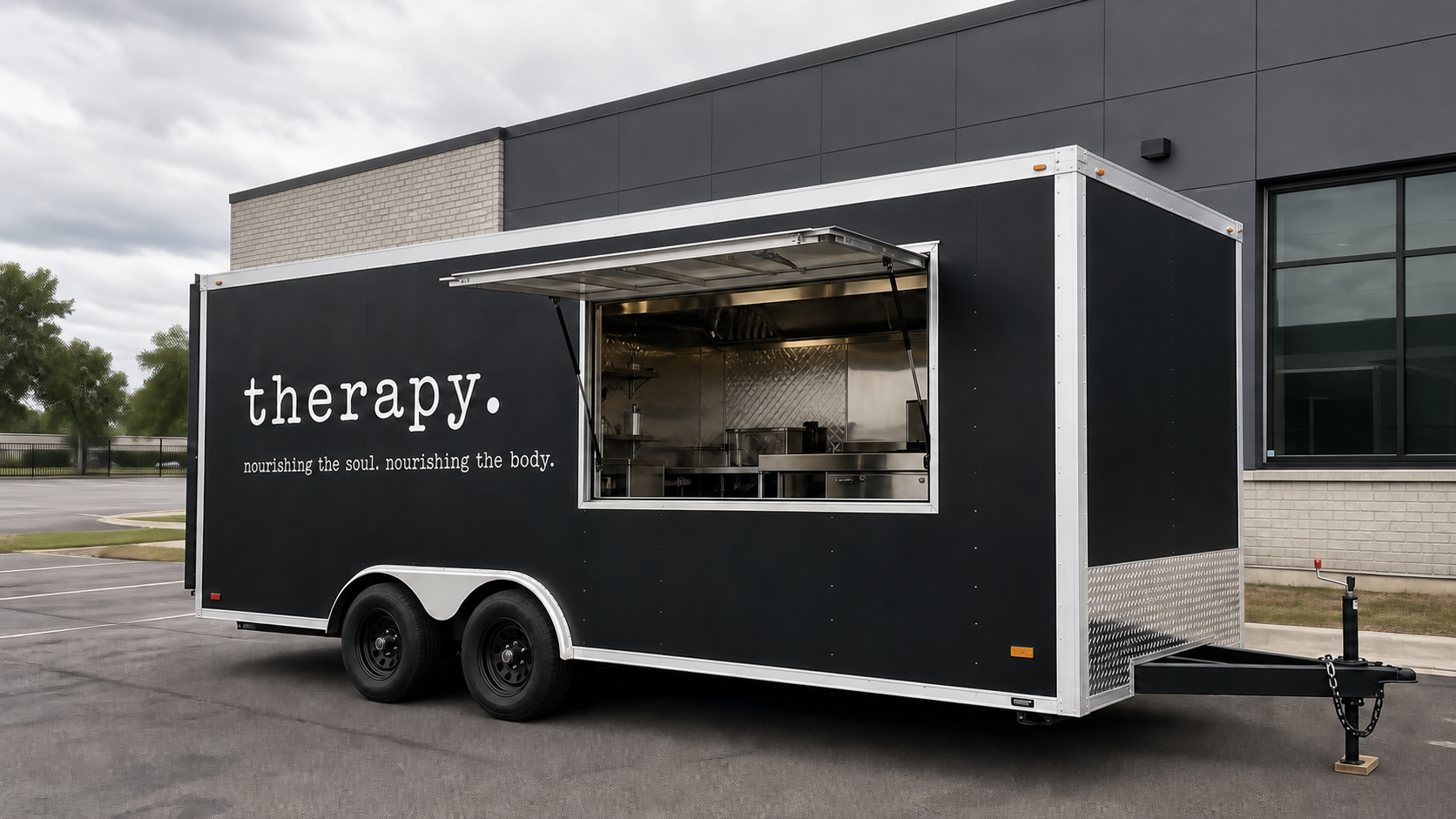 Realistic exterior view of the sharp rectangular black and white therapy. trailer with the words nourishing the soul. nourishing the body.